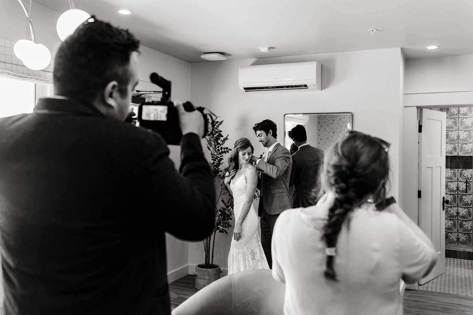 top wedding photo video team in Seattle documents a couple getting ready together in their suite on their wedding day