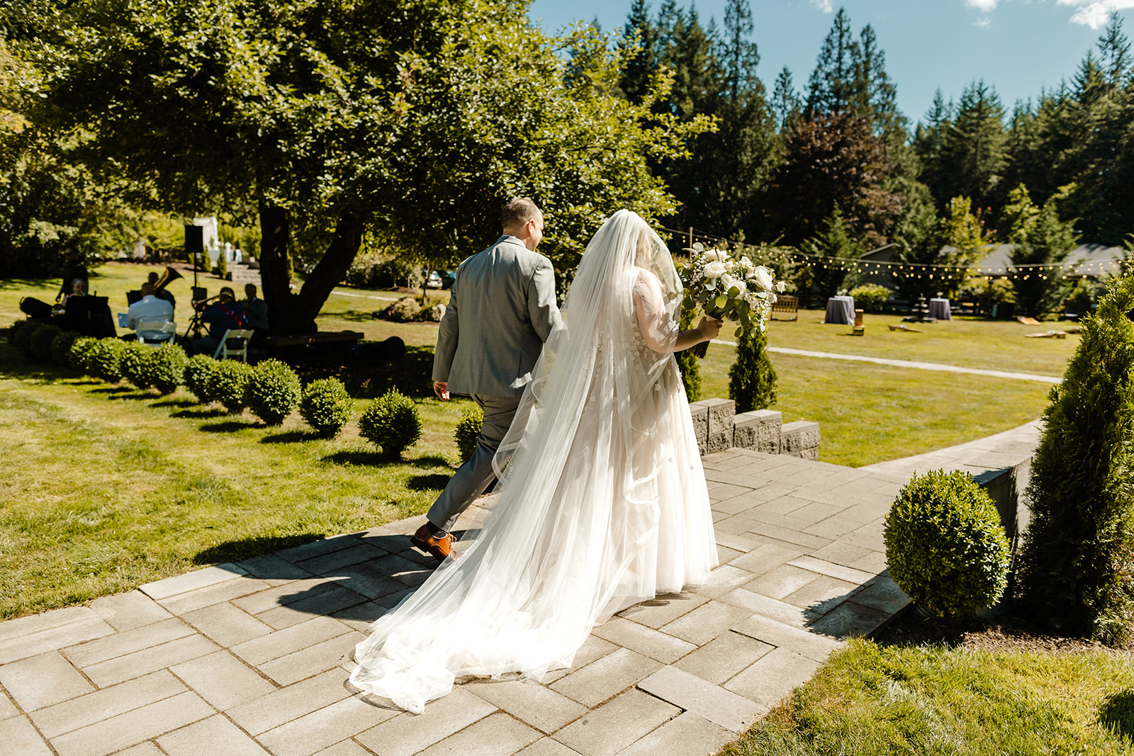 bride and groom walk out of ceremony at evergreen meadows