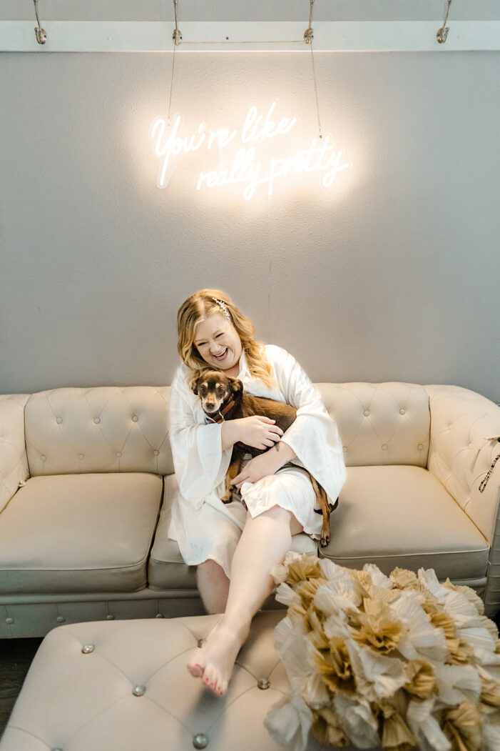 bride sits on couch with dog