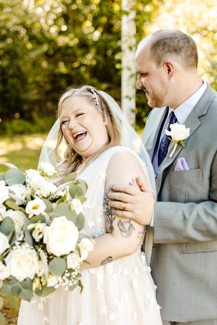 bride and groom laugh together