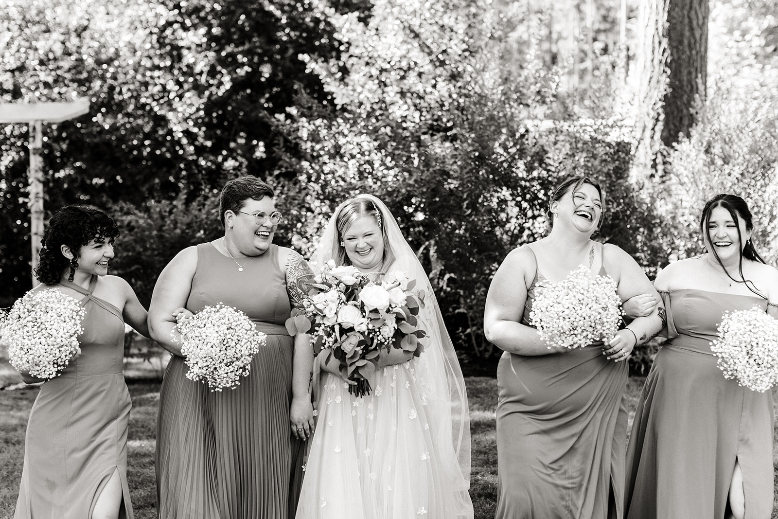 bride laughs with her bridesmaids