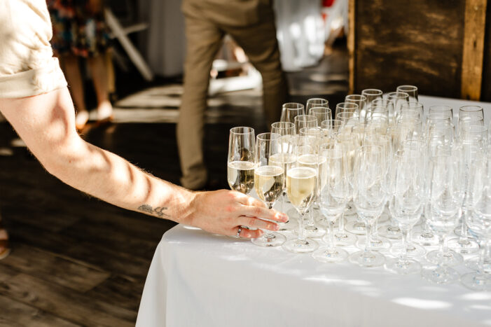 hand grabbing a glass of champagne