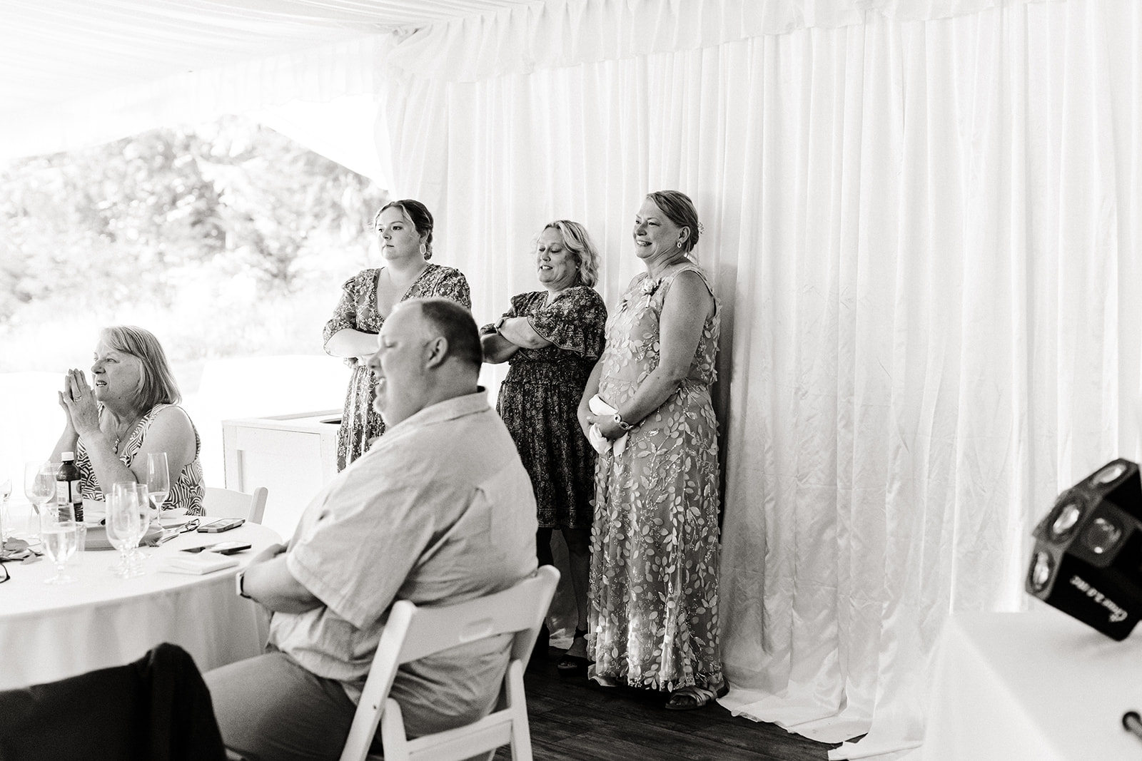 people stand to the side of reception watching first dance
