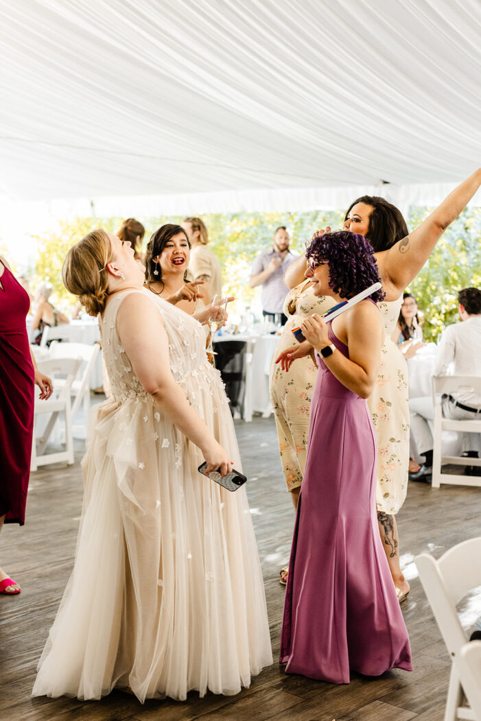 bride dances with guests at evergreen meadows wedding