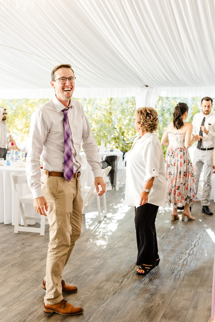 bride dances with guests at evergreen meadows wedding