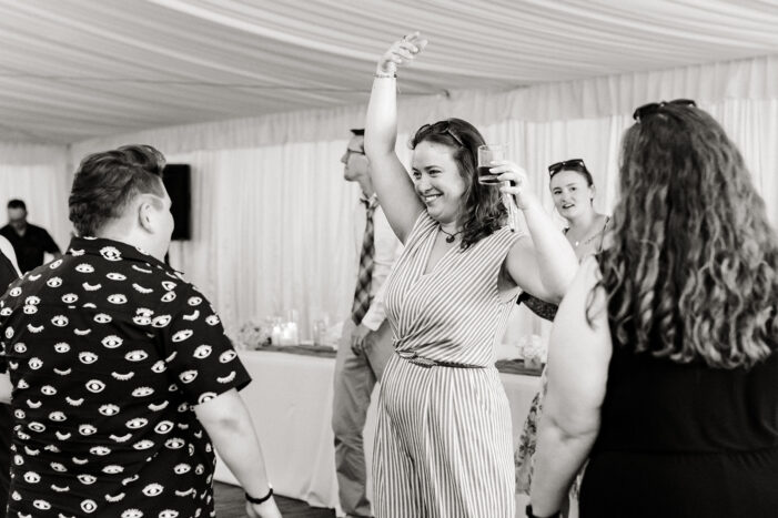 bride dances with guests at evergreen meadows wedding