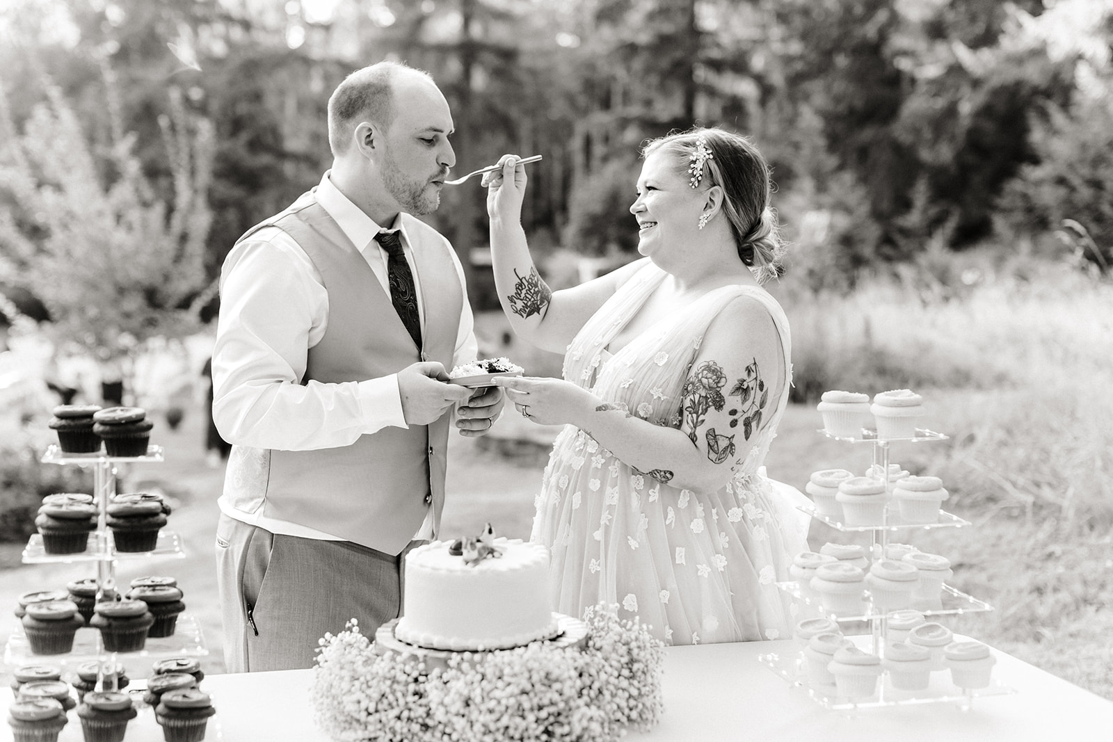 bride and groom feed each other cake