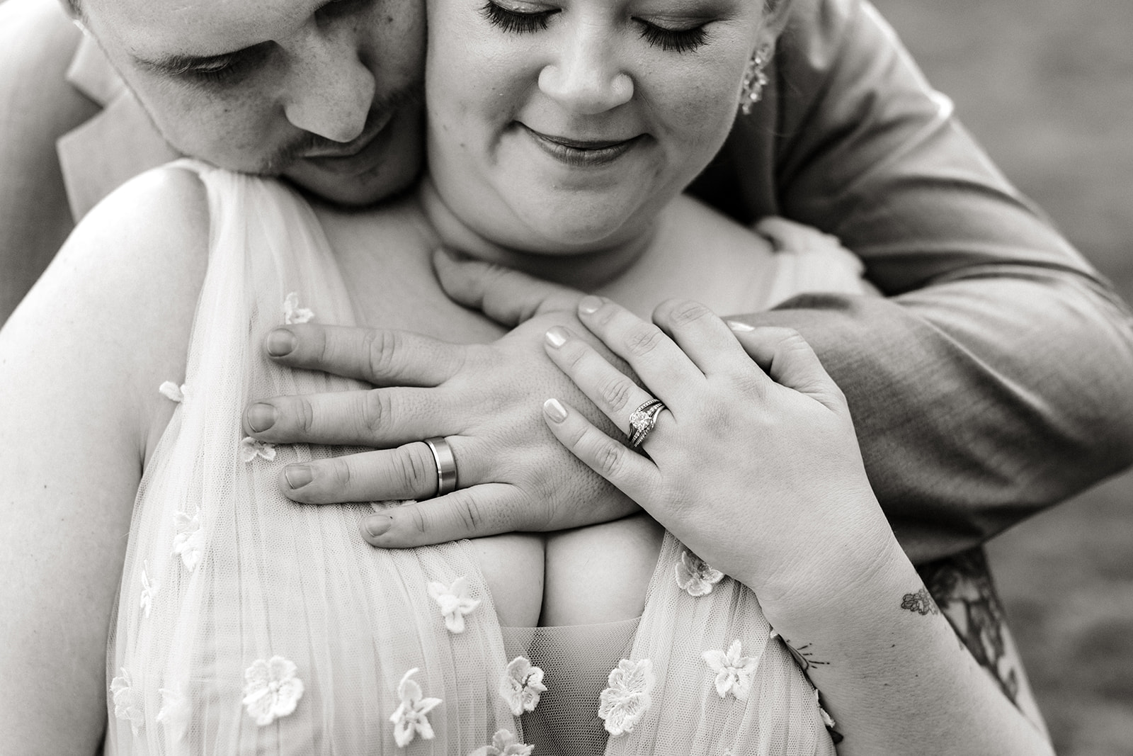 groom hugs bride from behind