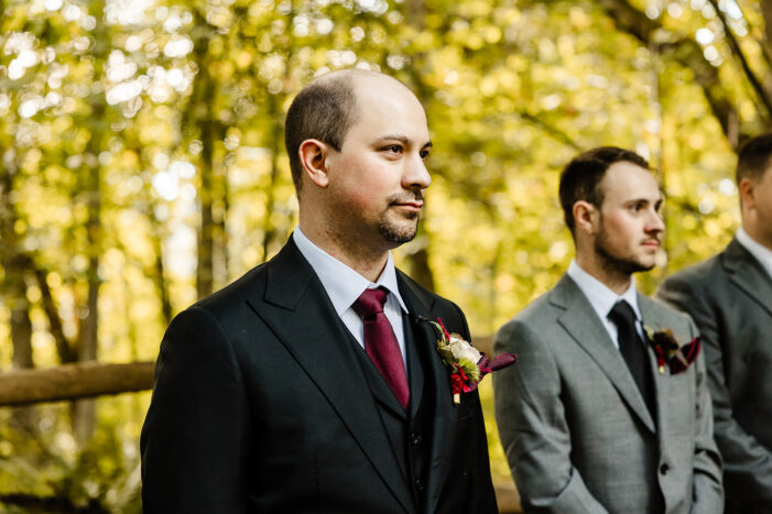 groom looking down aisle 