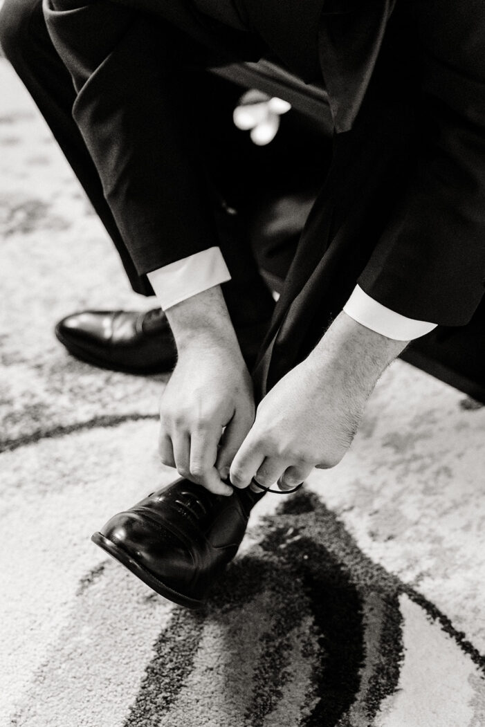 groom tying his shoe