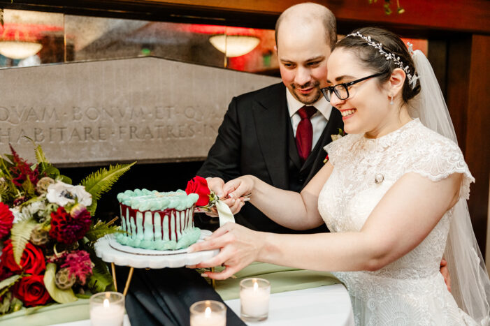 bride and groom cut cake
