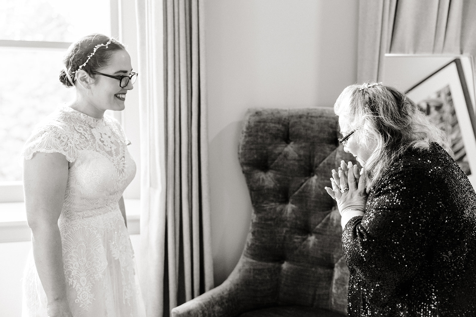 older woman cries as she looks at a bride