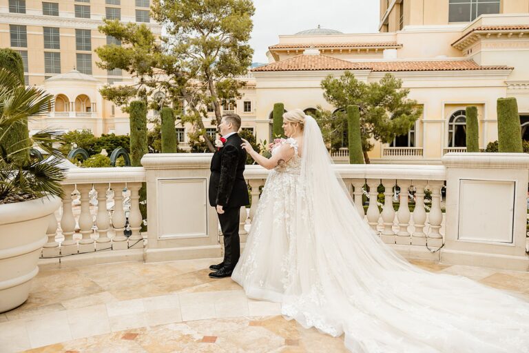 first look wedding photo between two brides at the patio of the bellagio in Las Vegas wedding photographer