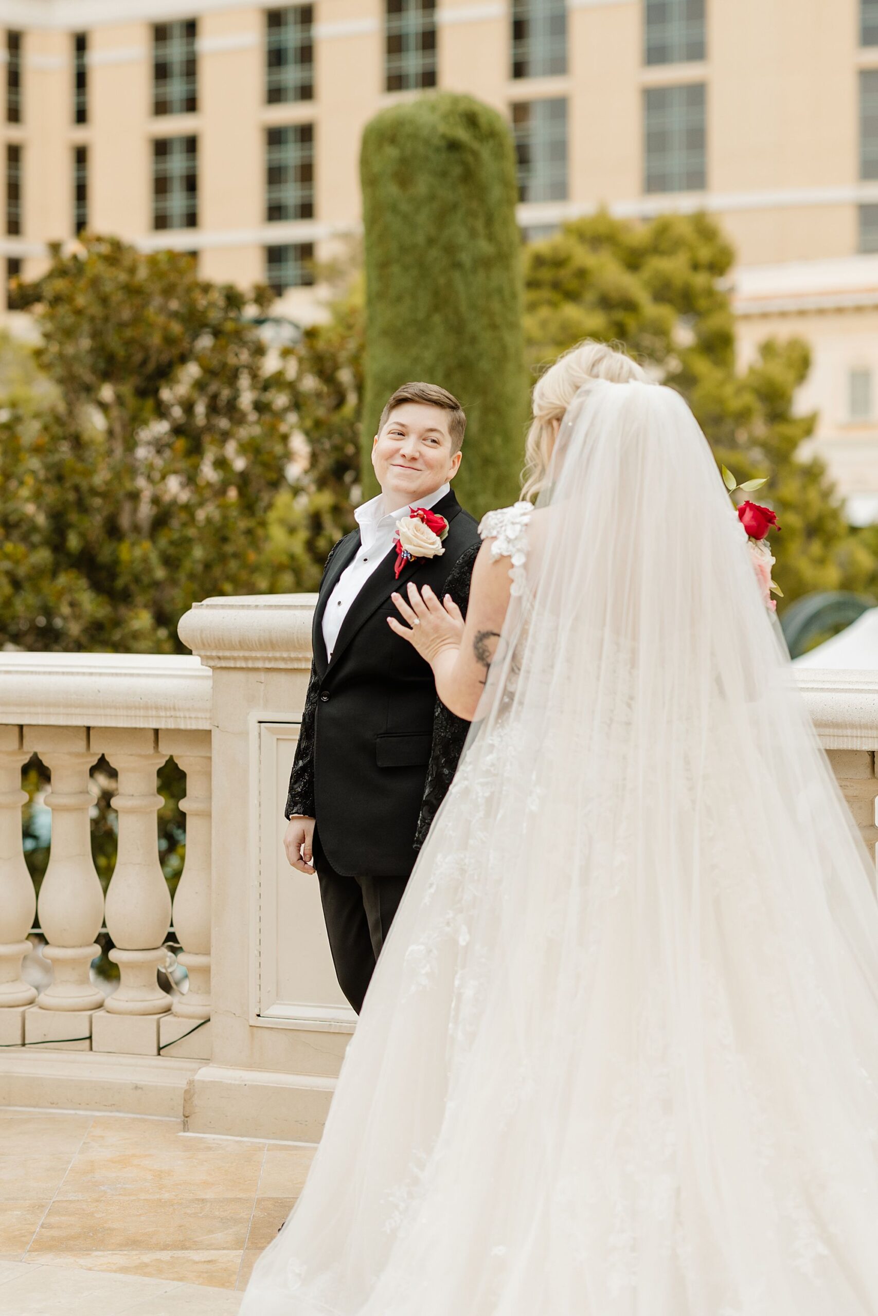 first look between two brides over the shoulder crying