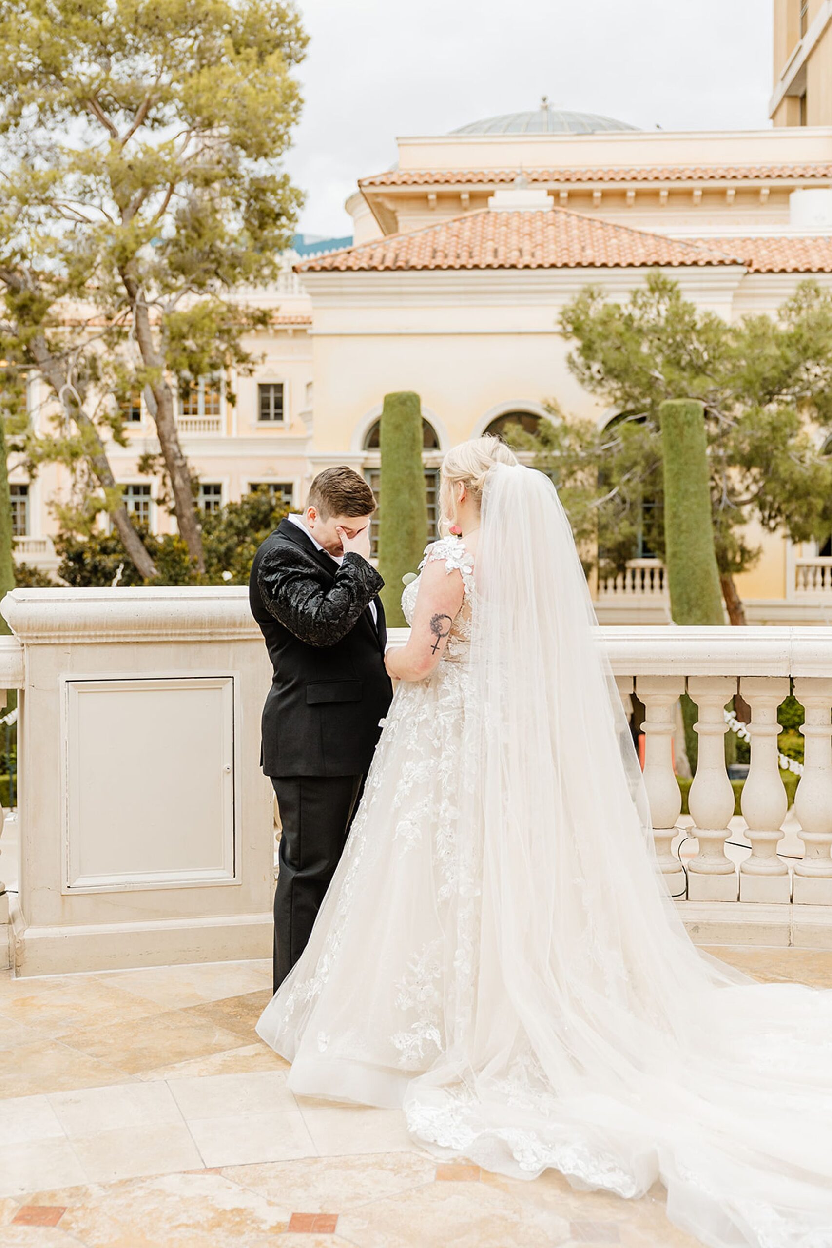 two brides standing outside crying tears of joy after first look wedding photo