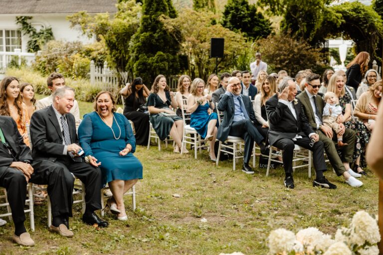 must have wedding photo of your guests at ceremony candid moment laughing