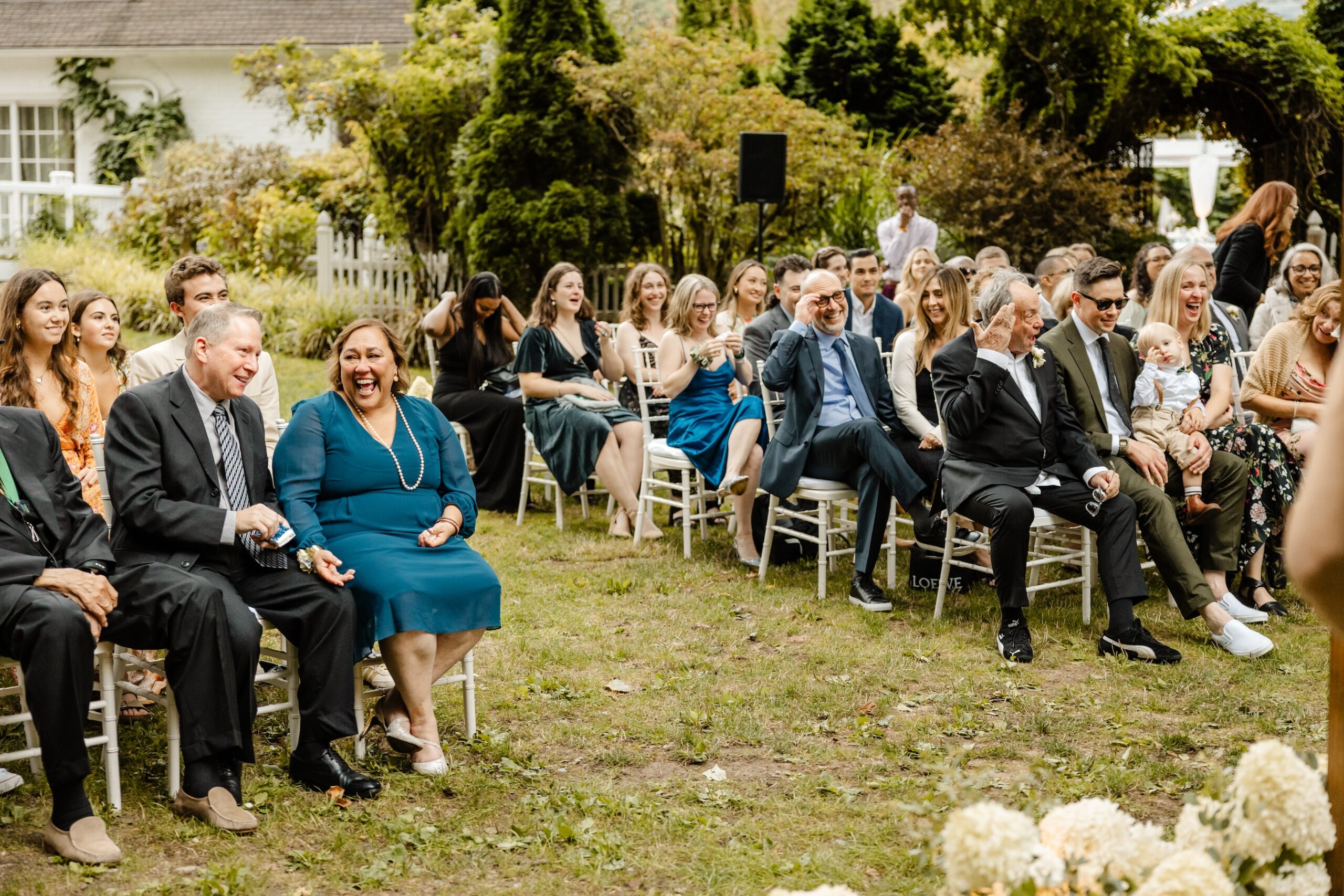must have wedding photo of your guests at ceremony candid moment laughing