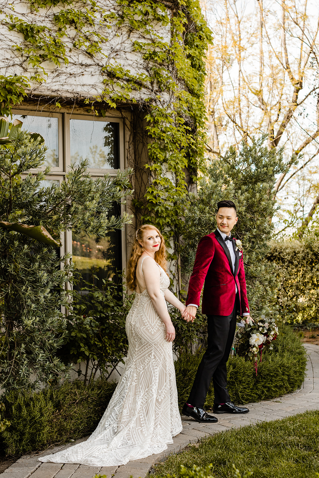 hollywood glam couple walking along path FAQ wedding photographer