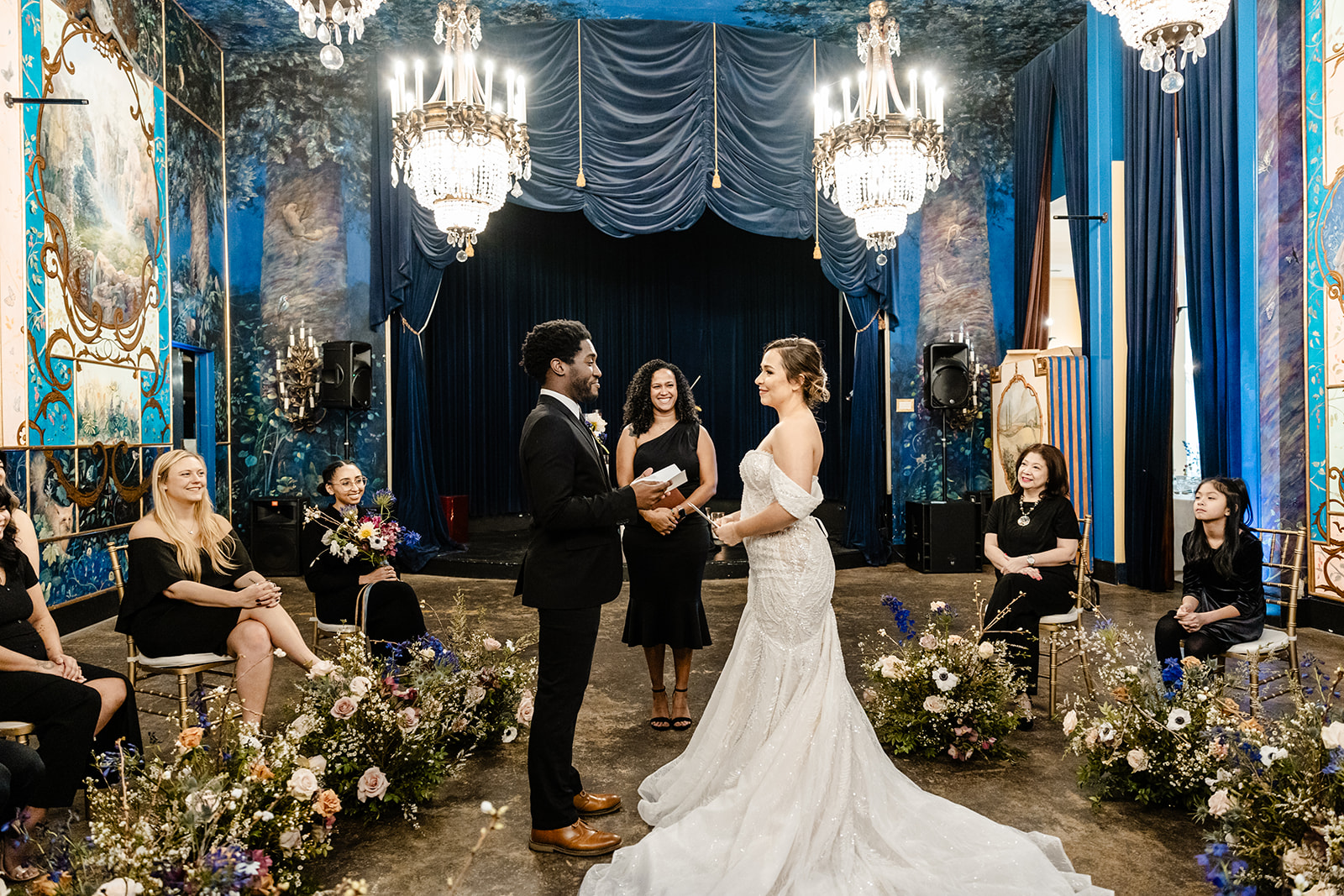 bride and groom stand holding hands at ceremony