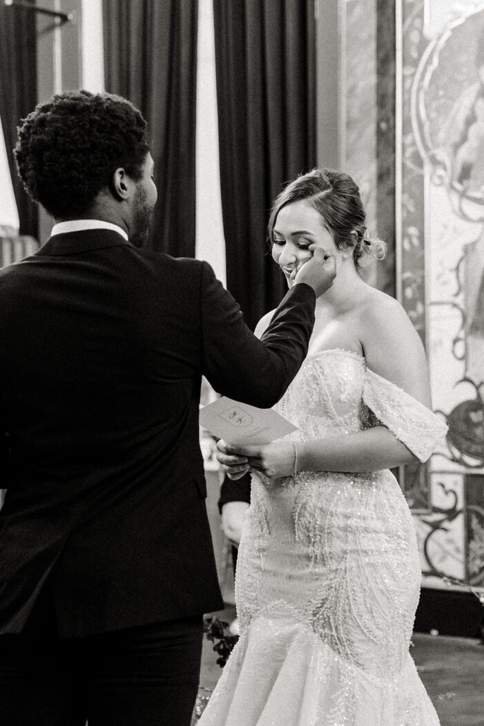 groom wipes tear off brides face