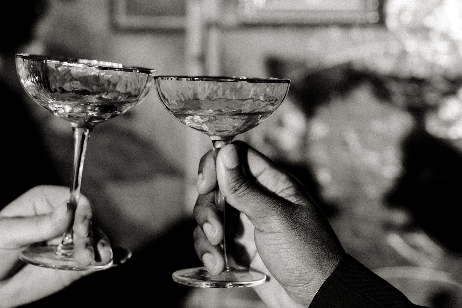 champagne glasses held up in toast