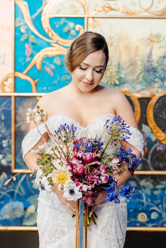 bride looks down at her florals
