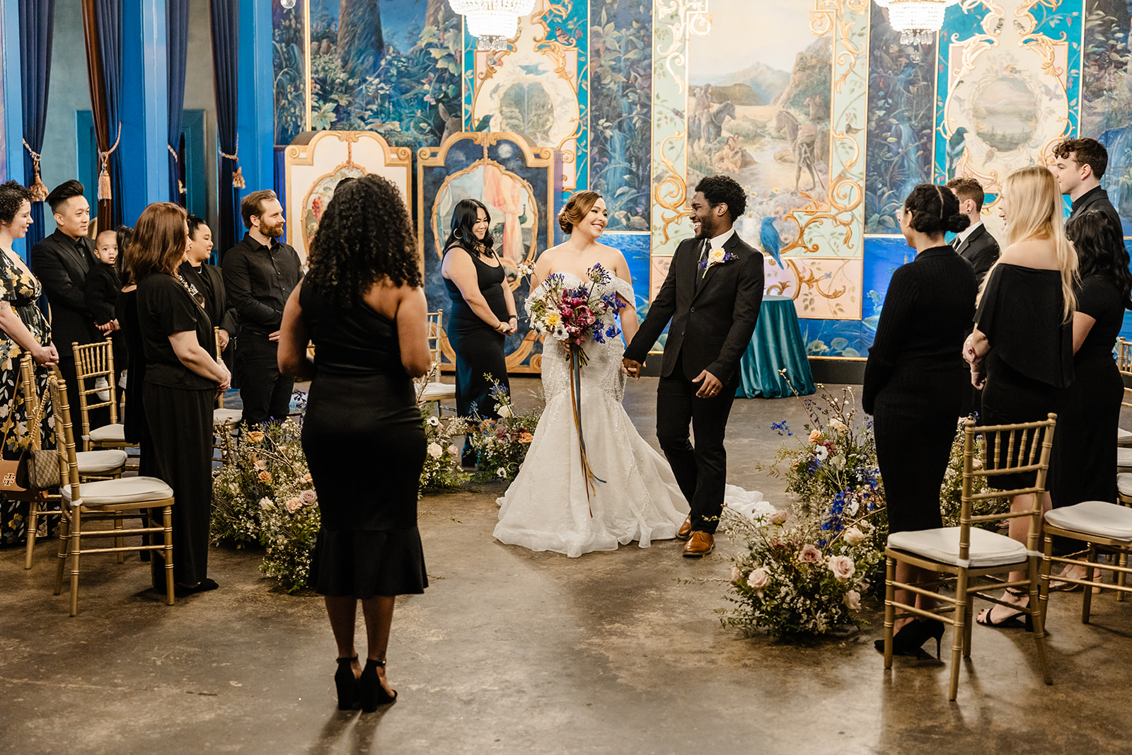 bride and groom walk down aisle