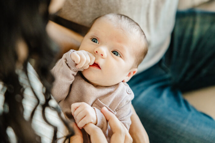 baby stares up at mom