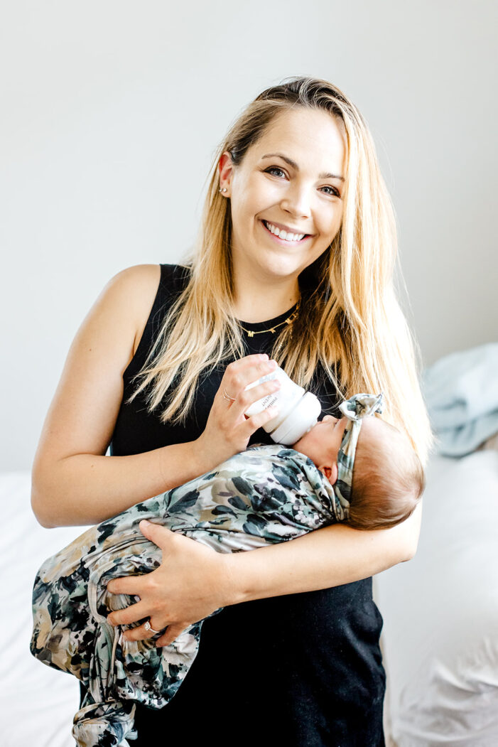 mom feeds baby with a bottle