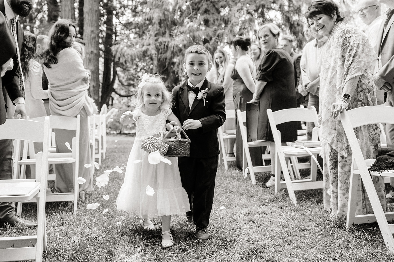two little kids walk down aisle