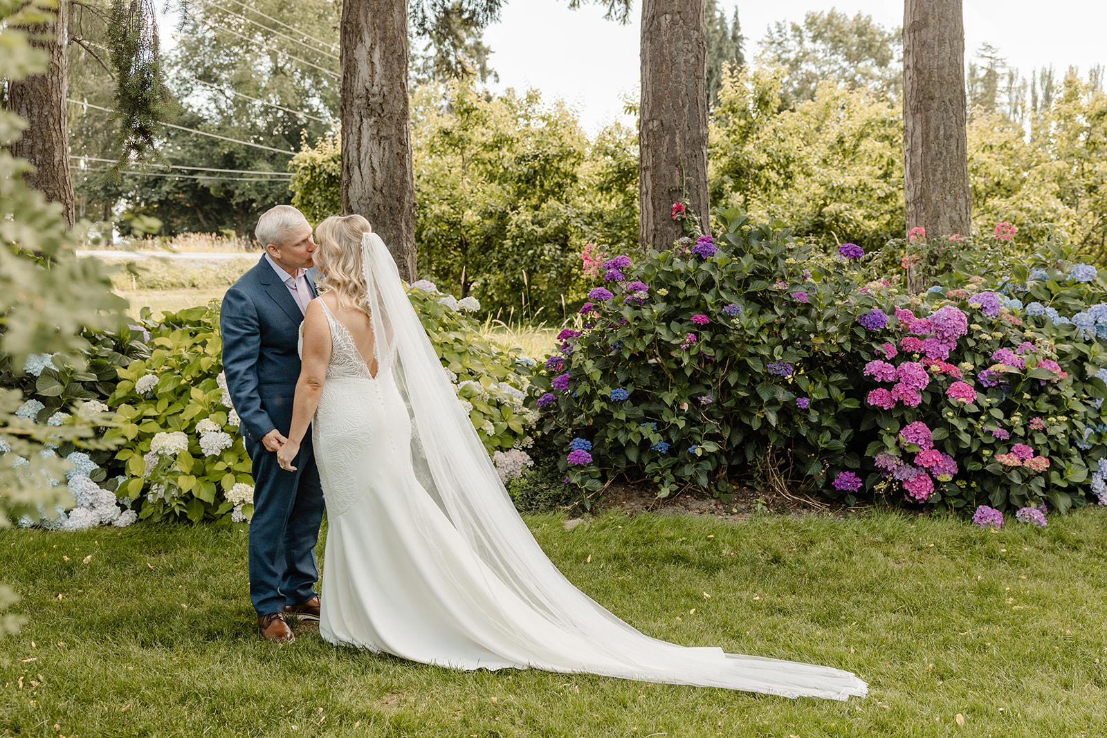 bride and groom kiss in garden
