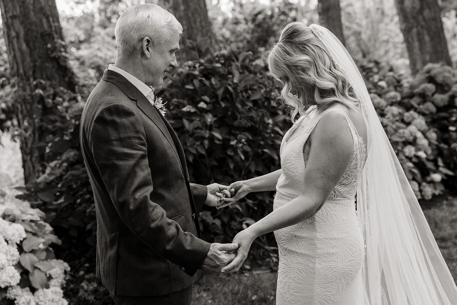 bride and groom hold hands in garden