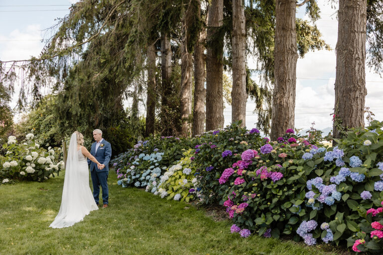 bride and groom holding hands in a garden