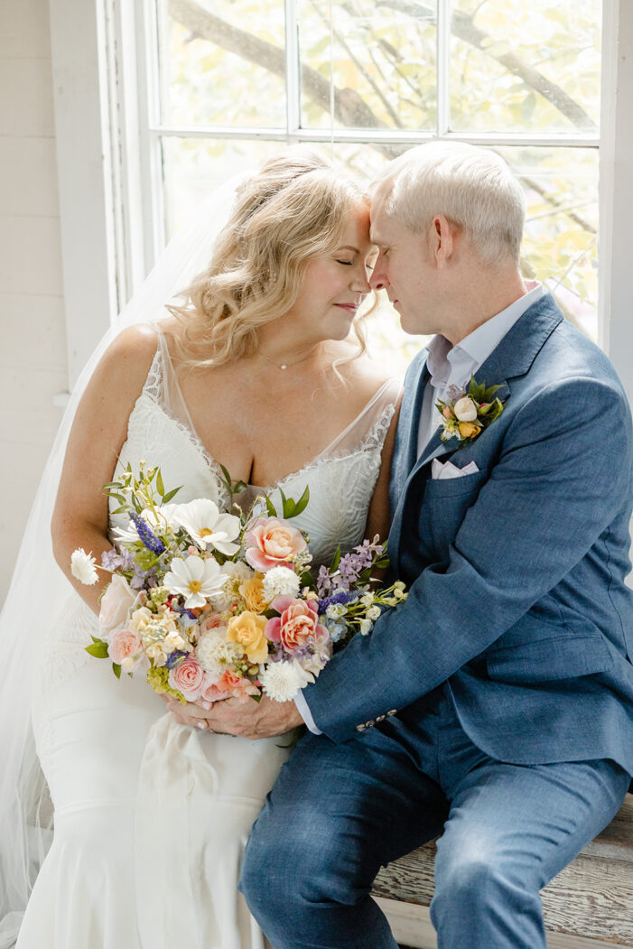 bride and groom rest foreheads togther