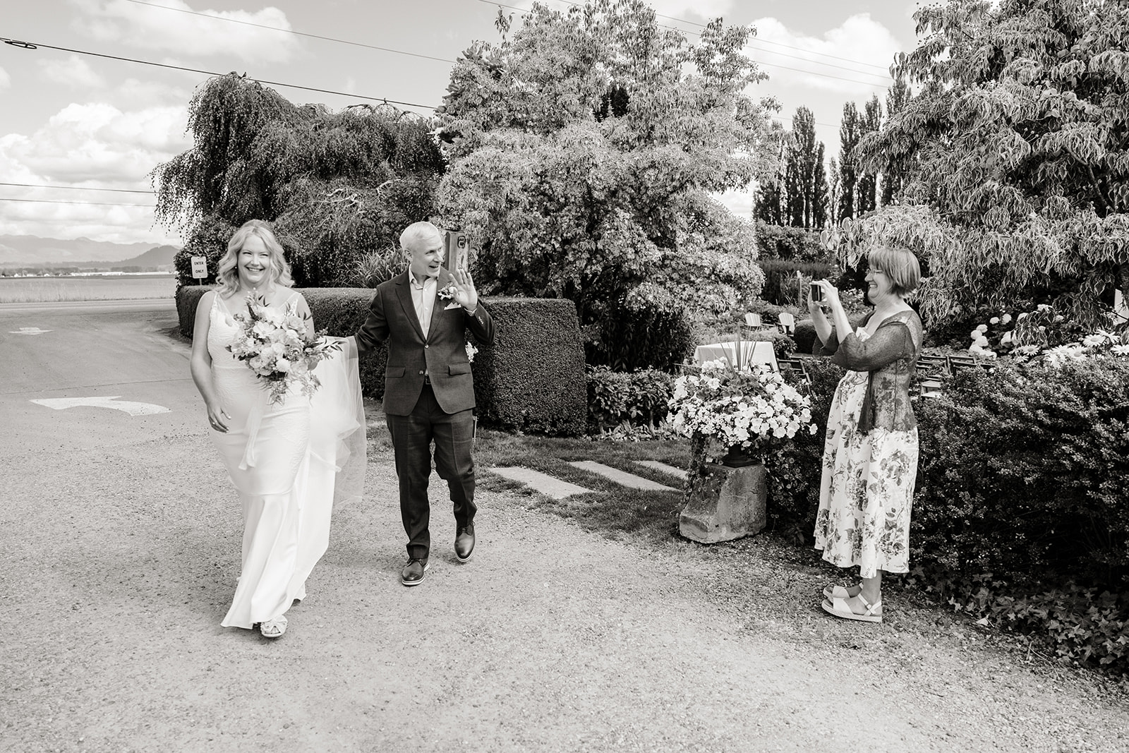 bride and groom walk through garden