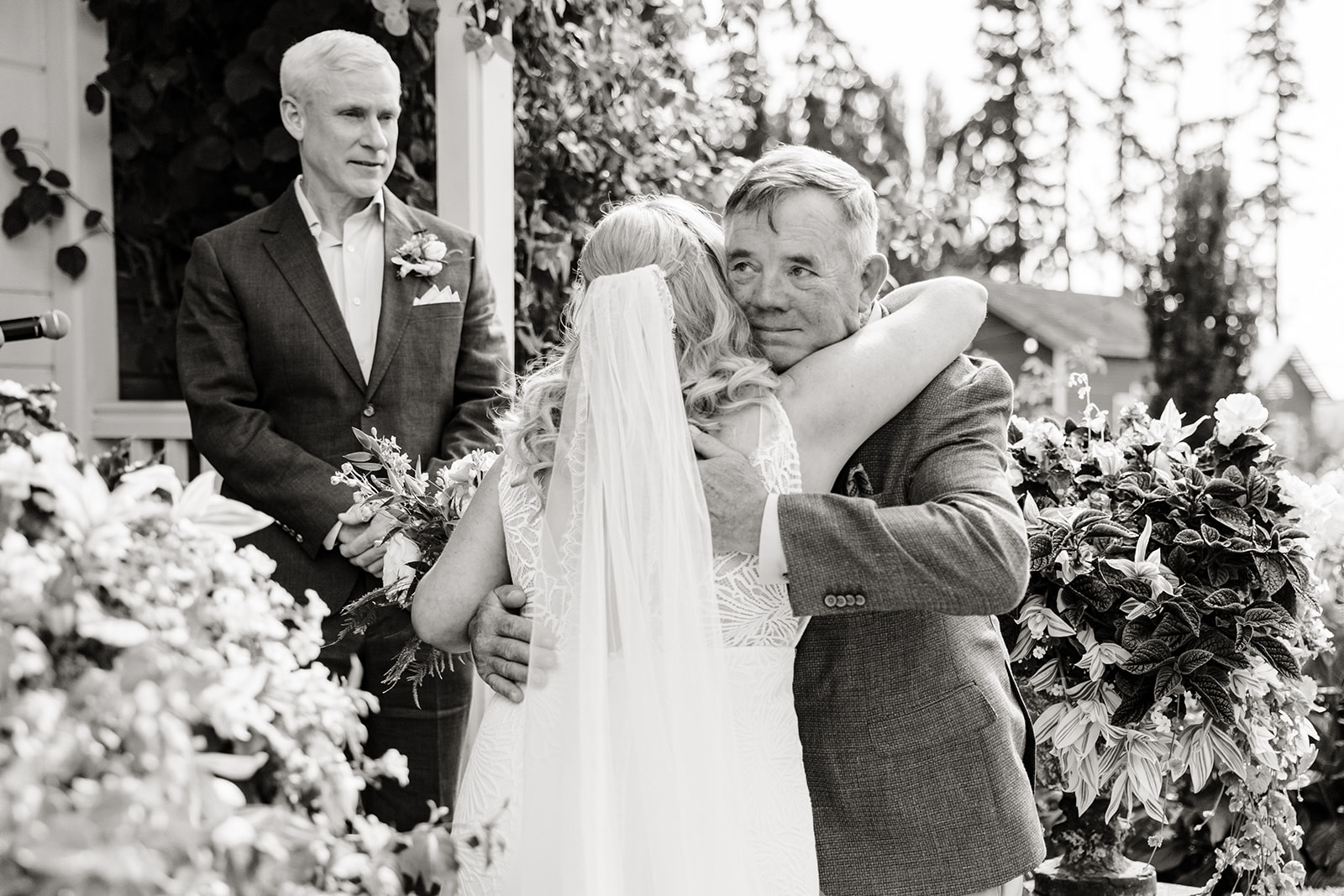 dad hugs bride at top of aisle