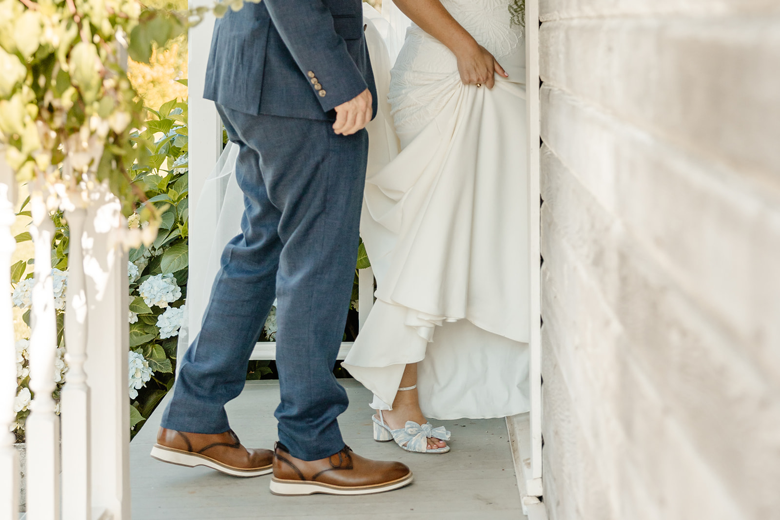 bride and groom walk into cottage