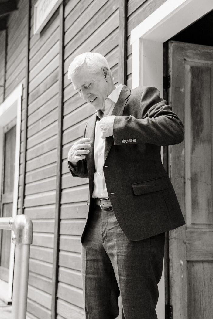 groom puts on jacket