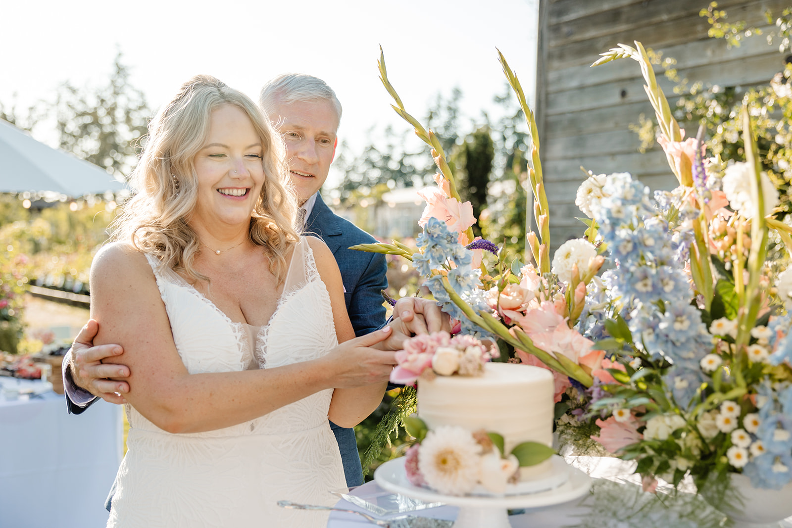 bride and groom cut cake at christianson's nursery