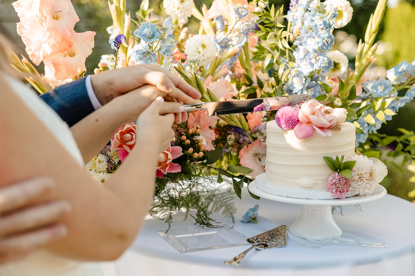 bride and groom cut cake at christianson's nursery