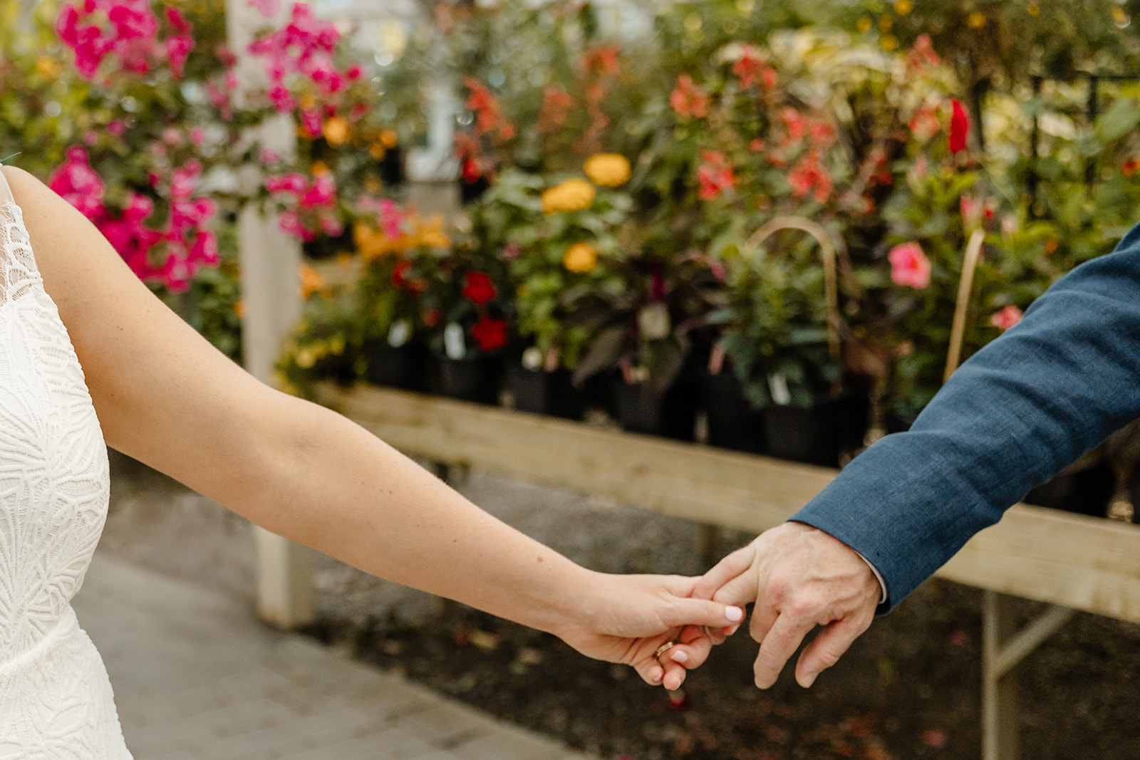 hands barely holding each other in garden