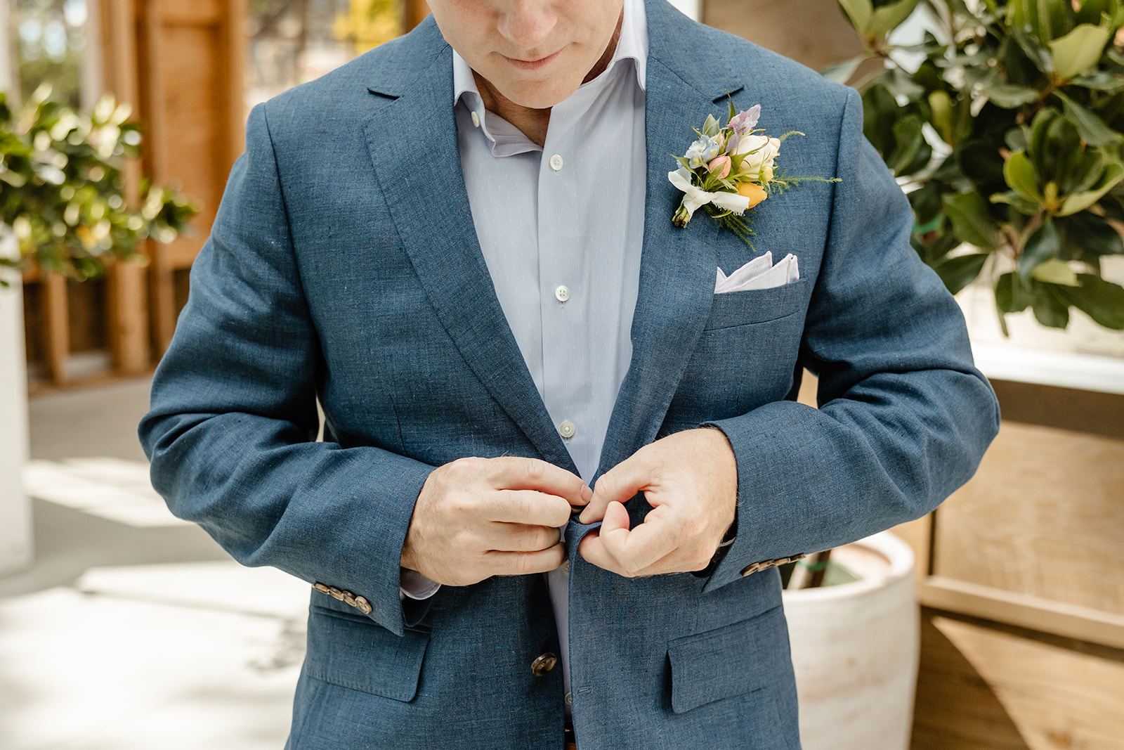 groom puts on jacket