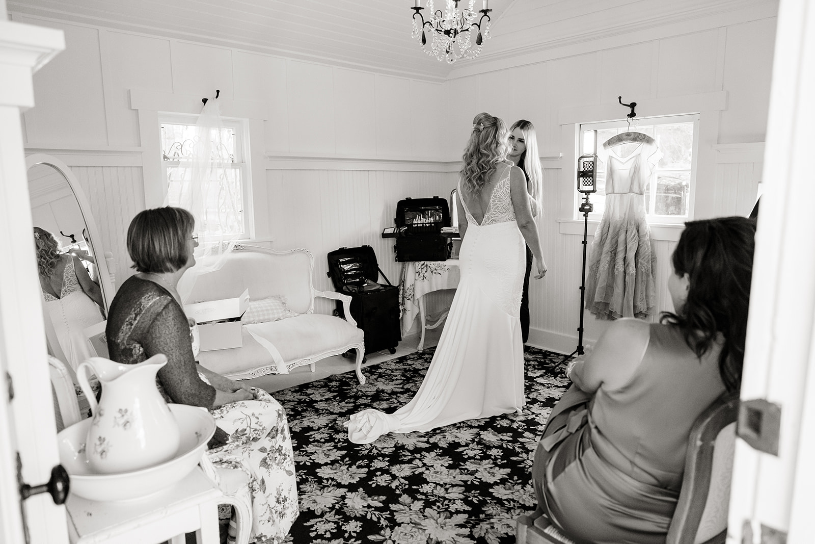 girls help bride get dressed