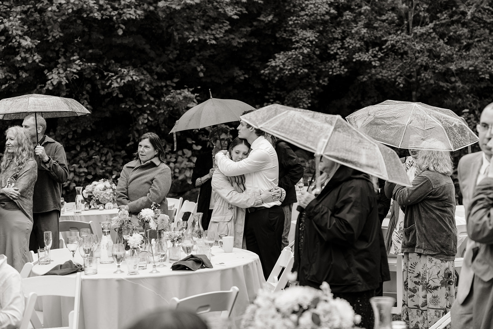 wedding guests standing in rain