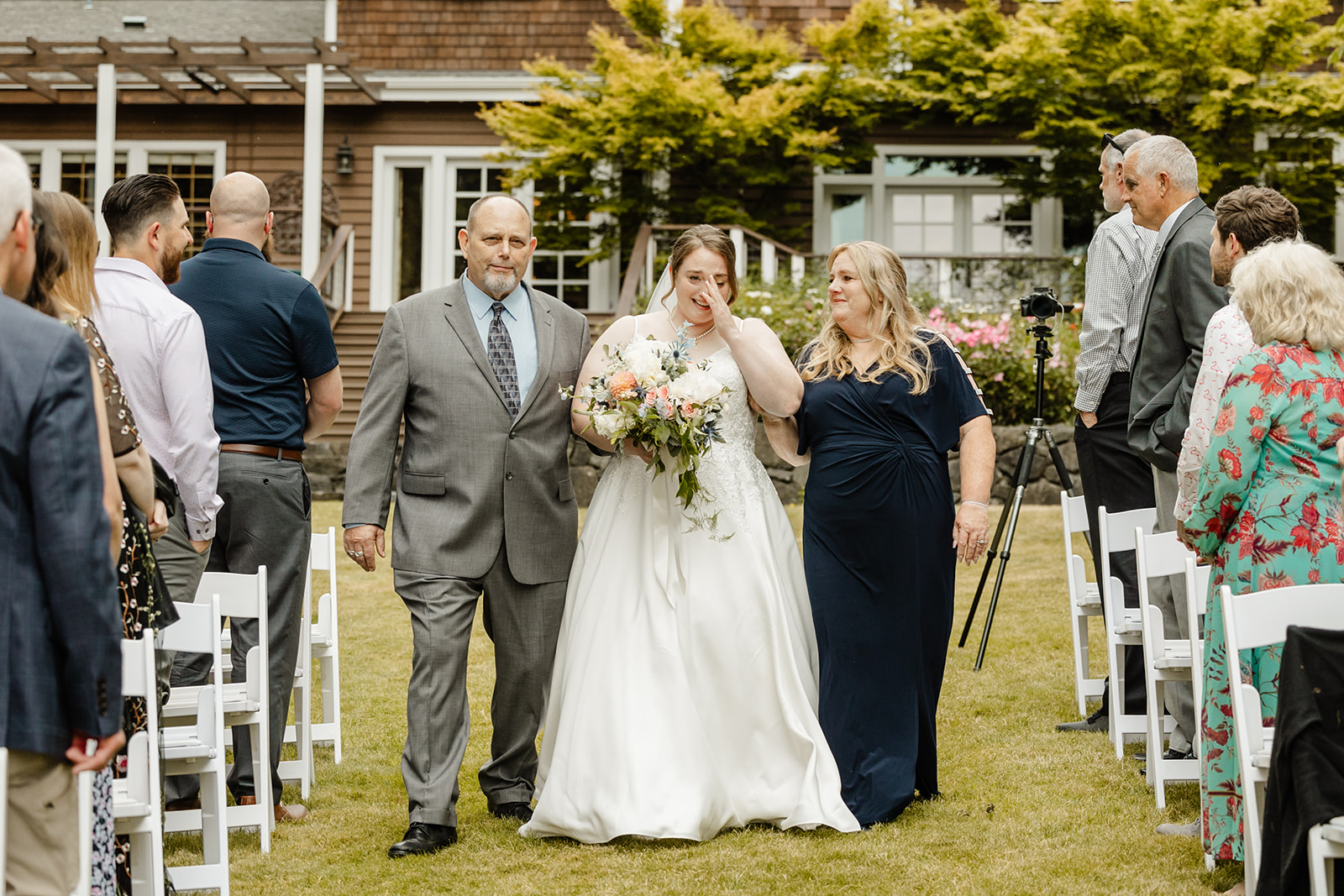 bride crying as she comes down aisle