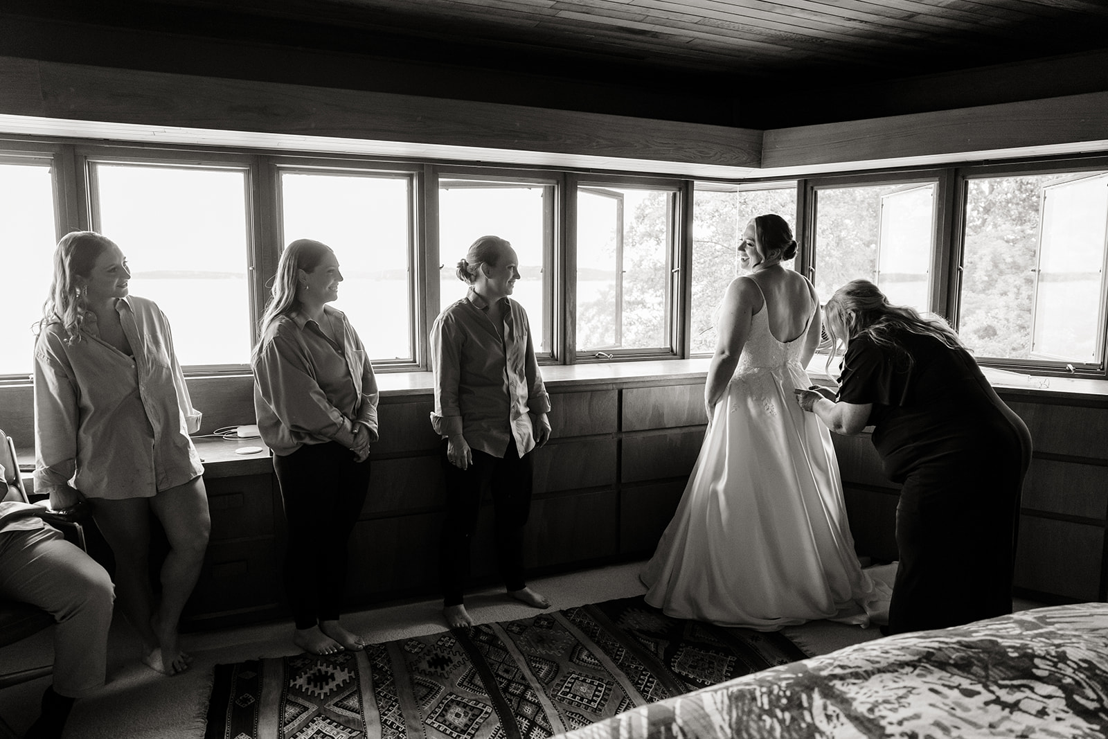entourage helping bride get dressed 