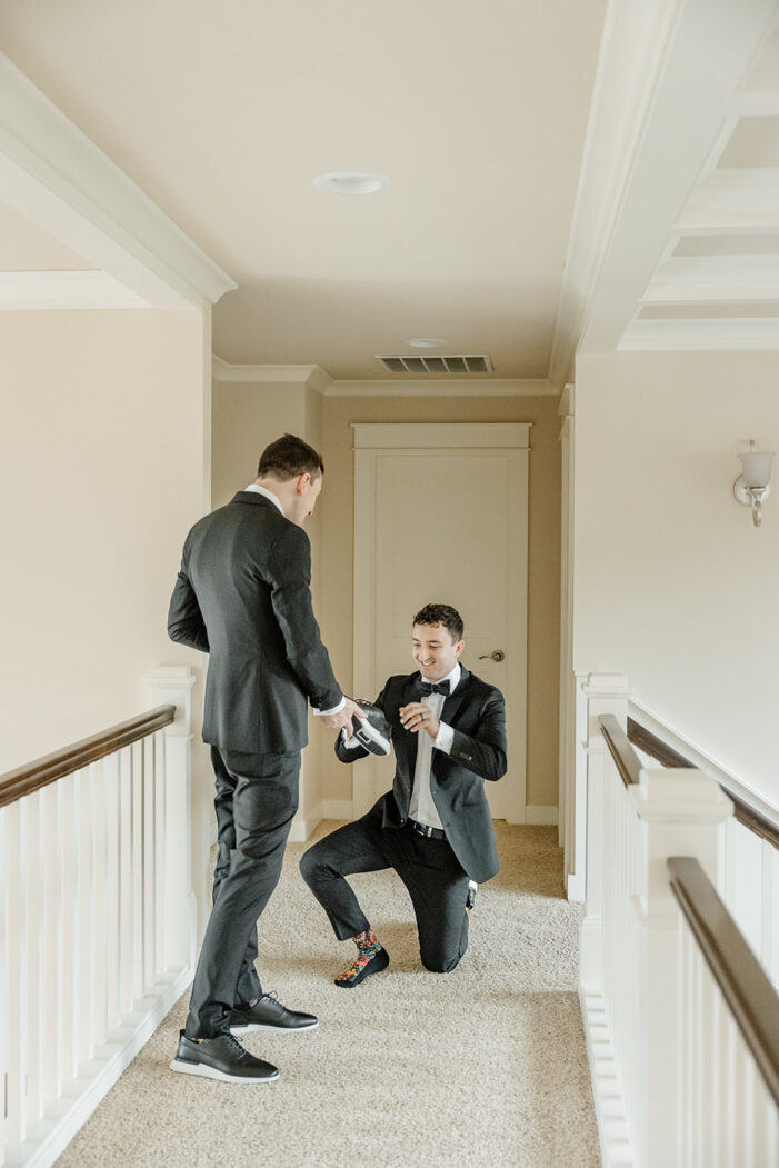 grooms help each other get dressed