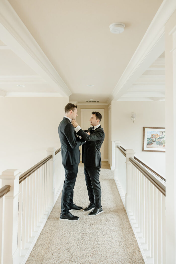 grooms help each other get dressed