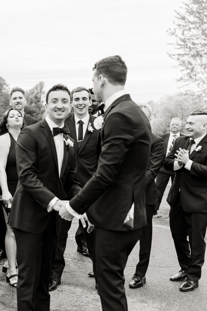 grooms surrounded by friends