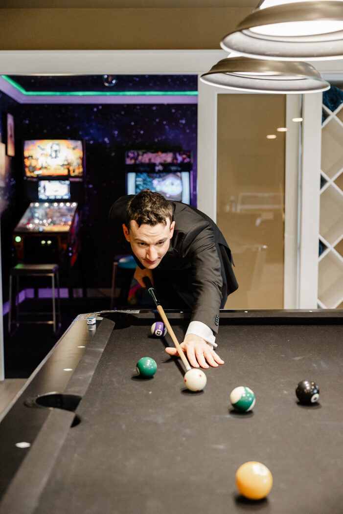 groom plays pool